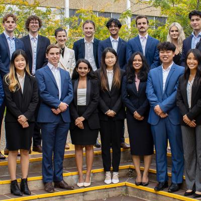 A group photo of the 2022 ANU Student Managed Fund team. They are in Copland Courtyard at ANU and are dressed in business attire.
