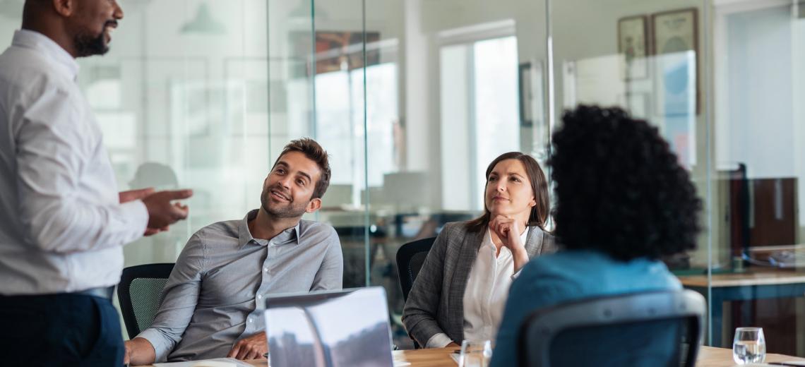 Four people talking in an office