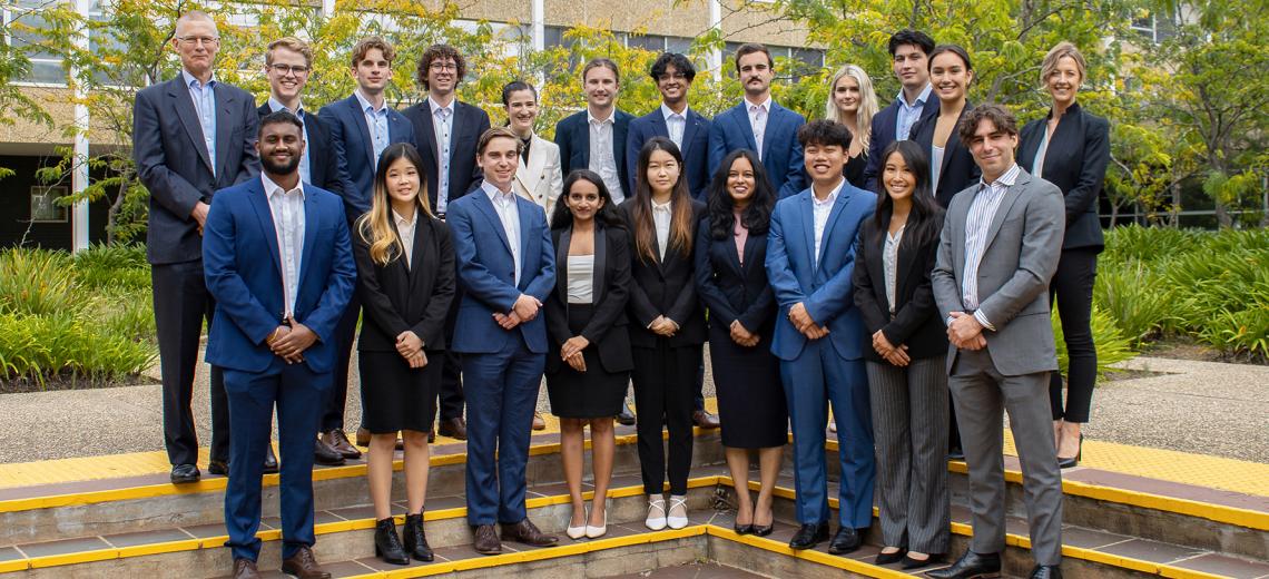 A group photo of the 2022 ANU Student Managed Fund team. They are in Copland Courtyard at ANU and are dressed in business attire.