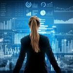 Woman looking at large screen of data
