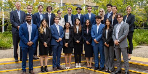 A group photo of the 2022 ANU Student Managed Fund team. They are in Copland Courtyard at ANU and are dressed in business attire.